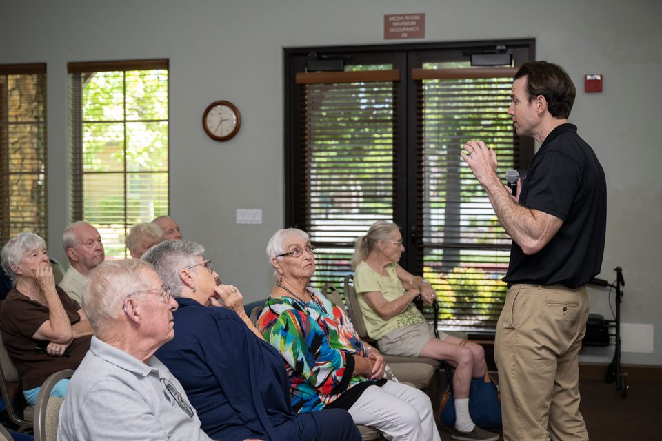 Kevin Kiley speaking with a microphone to seated seniors